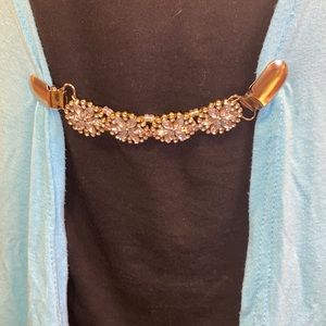 This is a handcrafted cardigan pin